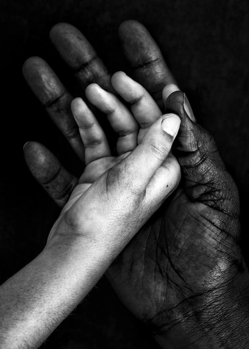 Adult hand and child hand